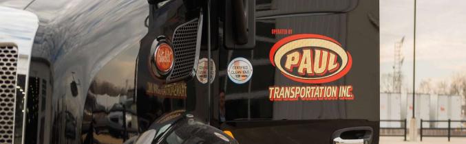 Side picture of a Paul Transportation truck.