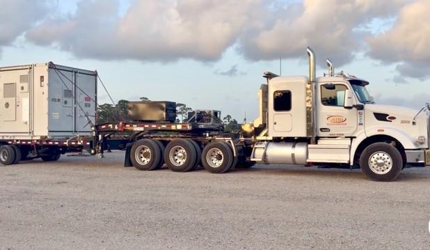 A Gulf States Trucking tractor with a loaded flatbed.