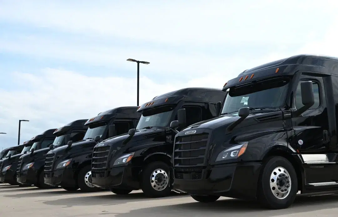 A lineup of Paul Transportation tractors on the yard.